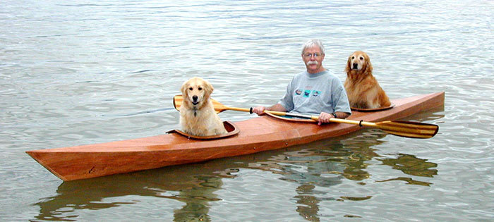 Both dogs sit comfortably in the kayak
